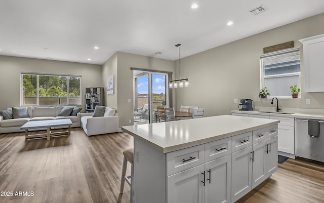 3367 W Lyra Way, Flagstaff, AZ 86001 - kitchen with a sink, dishwasher, open floor plan, light countertops, and a kitchen island