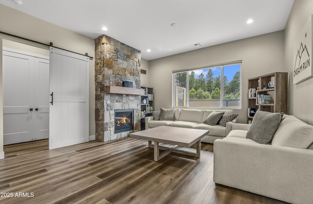 3367 W Lyra Way, Flagstaff, AZ 86001 - living room featuring wood finished floors, a barn door, recessed lighting, and a fireplace
