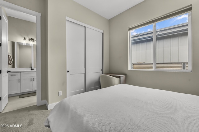 3367 W Lyra Way, Flagstaff, AZ 86001 - bedroom with light colored carpet, a closet, connected bathroom, a sink, and baseboards