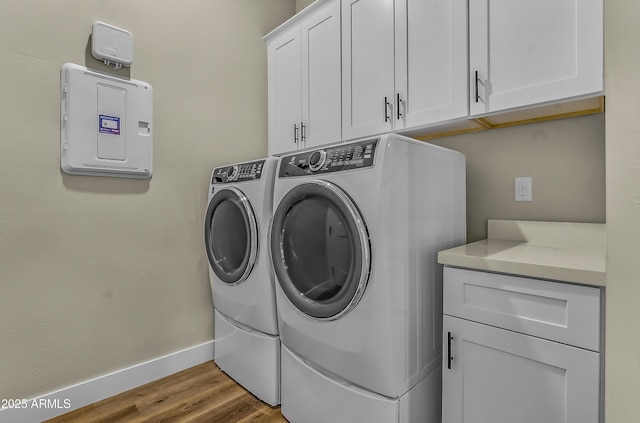 3367 W Lyra Way, Flagstaff, AZ 86001 - laundry area featuring cabinet space, washer and clothes dryer, baseboards, wood finished floors, and electric panel