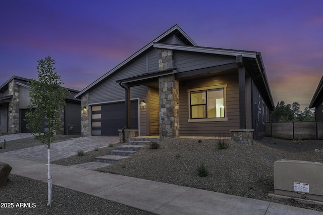 3367 W Lyra Way, Flagstaff, AZ 86001 - view of front facade featuring an attached garage, decorative driveway, and stone siding