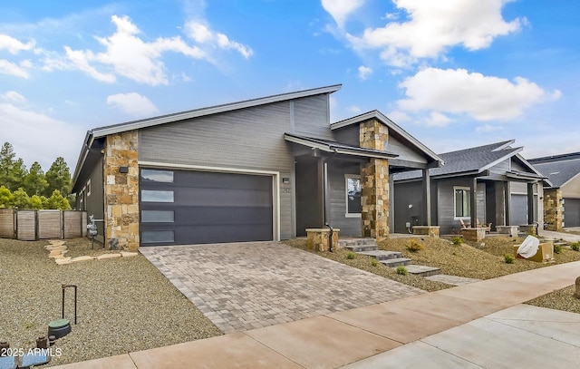 3367 W Lyra Way, Flagstaff, AZ 86001 - contemporary home with decorative driveway, an attached garage, and stone siding