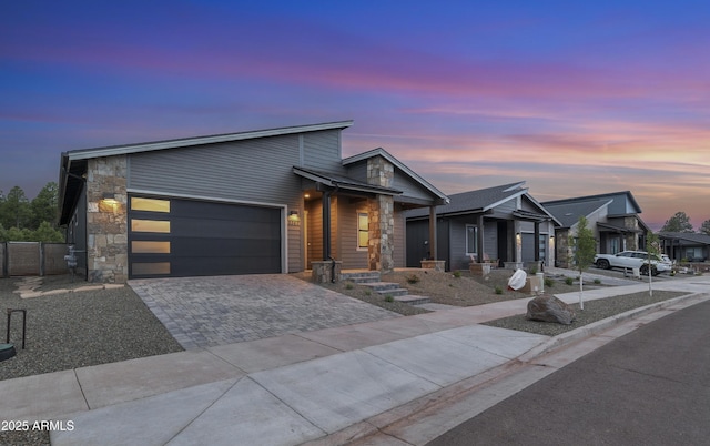 3367 W Lyra Way, Flagstaff, AZ 86001 - modern home featuring driveway, a garage, and stone siding