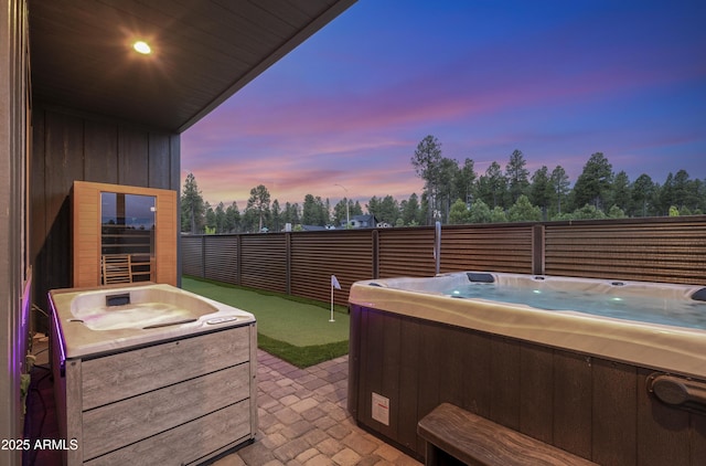 3367 W Lyra Way, Flagstaff, AZ 86001 - view of patio / terrace with a hot tub, a putting area, and view of wooded area