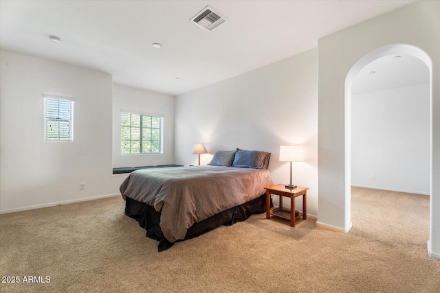 bedroom with light colored carpet