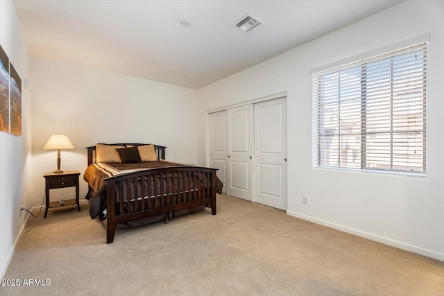 carpeted bedroom with a closet