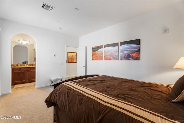 carpeted bedroom with connected bathroom