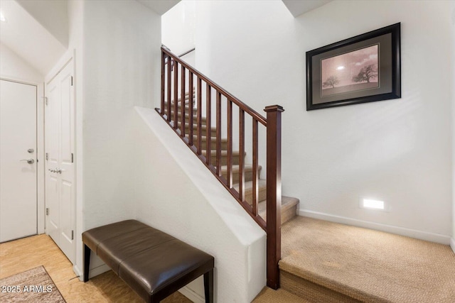 stairway featuring carpet