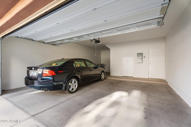 garage featuring a garage door opener and electric panel