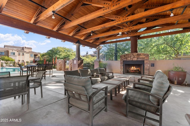 view of patio / terrace featuring a gazebo and an outdoor living space with a fireplace