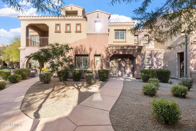 mediterranean / spanish home with a balcony