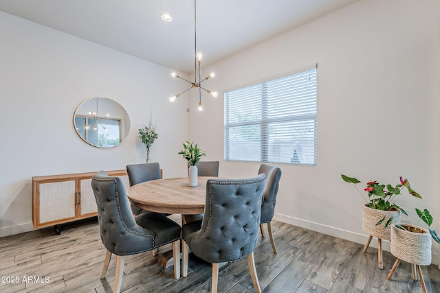 dining room featuring light wood-style flooring, a notable chandelier, recessed lighting, and baseboards