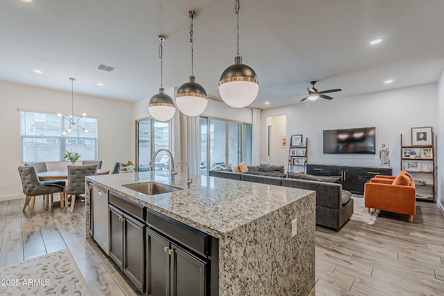 kitchen featuring a wealth of natural light, light wood-type flooring, and a sink