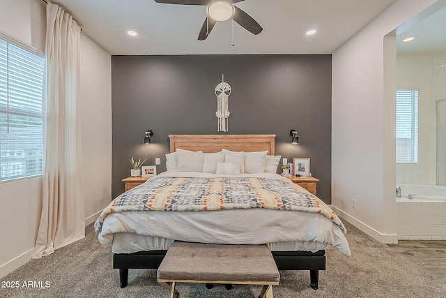 bedroom with carpet flooring, a ceiling fan, baseboards, and ensuite bathroom