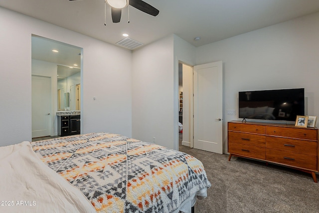 bedroom with ceiling fan, visible vents, ensuite bath, and dark carpet