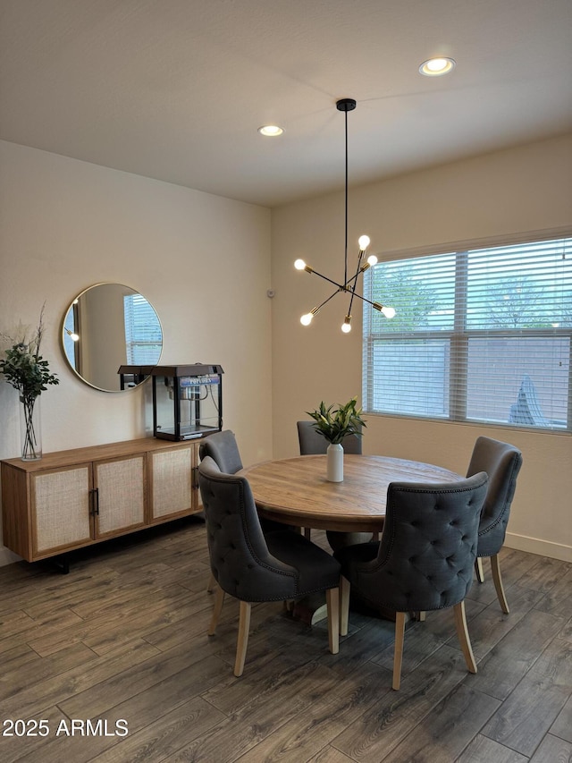 dining area featuring recessed lighting, baseboards, dark wood-type flooring, and an inviting chandelier