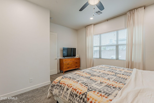 carpeted bedroom featuring visible vents, baseboards, and a ceiling fan