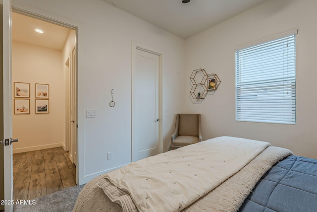 bedroom with baseboards and wood finished floors