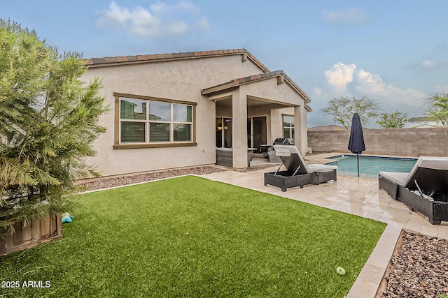 back of house featuring a fenced in pool, stucco siding, a lawn, a fenced backyard, and a patio