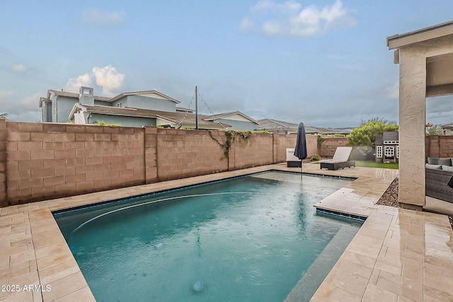 view of swimming pool featuring a fenced in pool, a patio, and a fenced backyard