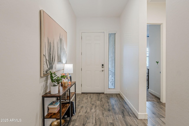 entryway with wood finished floors and baseboards