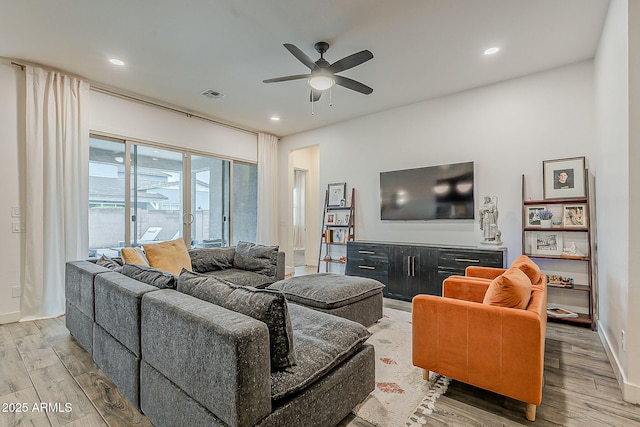 living room with visible vents, baseboards, recessed lighting, wood finished floors, and a ceiling fan