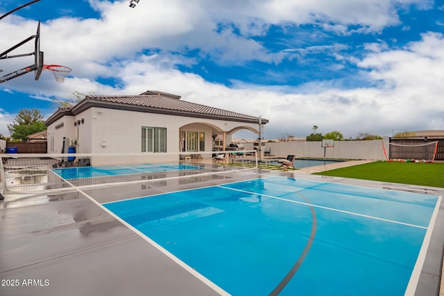 view of pool with a fenced in pool, a patio, basketball court, and fence