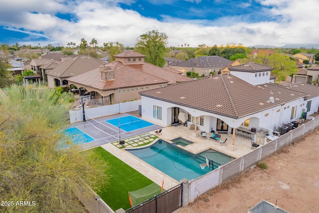 view of pool featuring a patio area, a fenced backyard, and a residential view