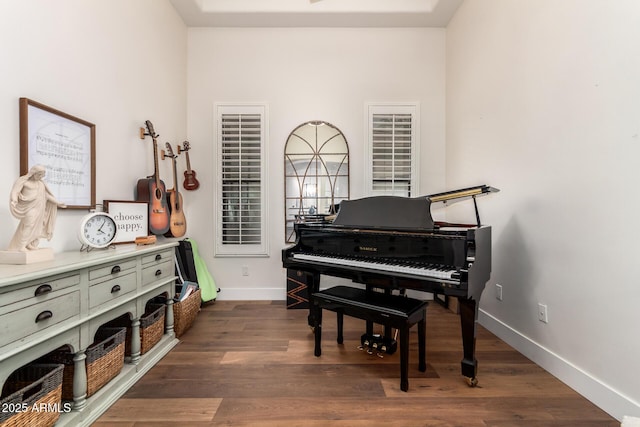 sitting room featuring baseboards and dark wood-style flooring