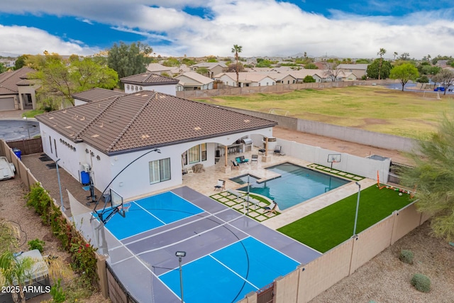 view of pool featuring a tennis court, a patio, a fenced backyard, a residential view, and a fenced in pool