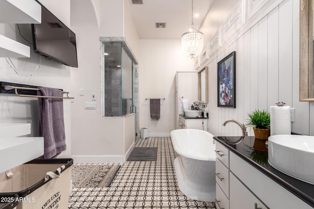 bathroom featuring a soaking tub, visible vents, a shower stall, and vanity