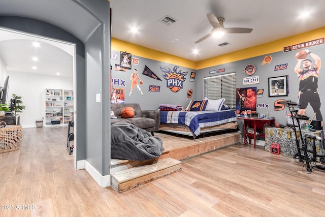 bedroom featuring baseboards, visible vents, and light wood finished floors