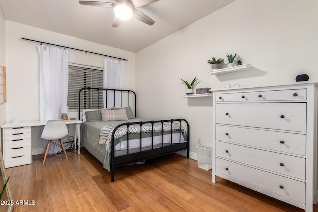 bedroom with baseboards, light wood-style floors, and a ceiling fan