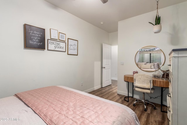 bedroom featuring baseboards and dark wood finished floors