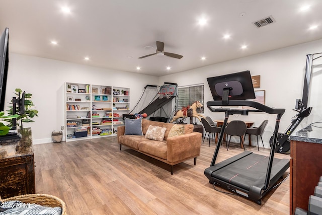 workout area with light wood-style floors, recessed lighting, a ceiling fan, and visible vents