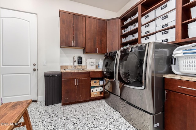 laundry room featuring a sink, cabinet space, and washing machine and dryer