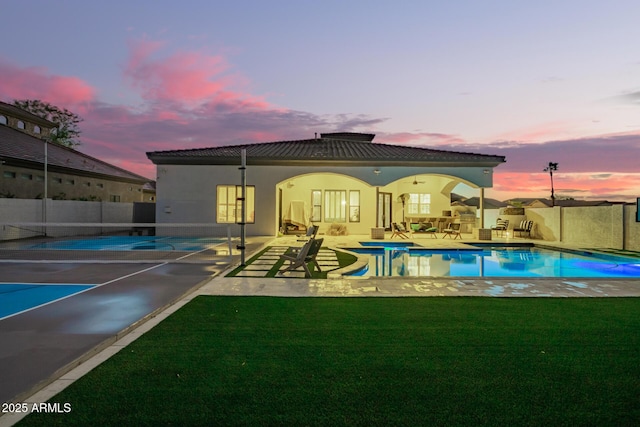 view of swimming pool with a patio area, a lawn, a fenced in pool, and fence