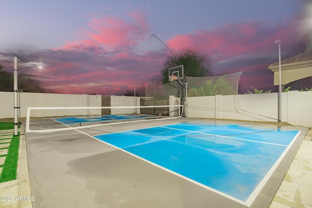 view of basketball court with a tennis court, community basketball court, and fence