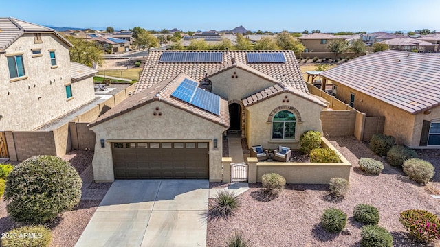 view of front of house featuring a fenced front yard, a tile roof, driveway, a residential view, and a gate