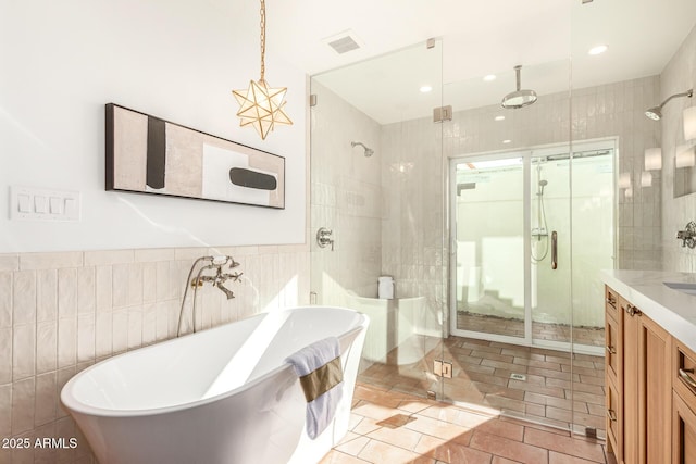 16227 N 63rd Pl, Scottsdale, AZ 85254 - bathroom featuring a shower stall, vanity, tile walls, a soaking tub, and recessed lighting