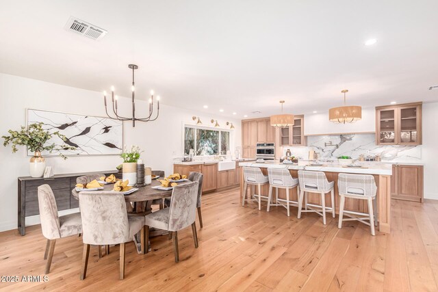 16227 N 63rd Pl, Scottsdale, AZ 85254 - dining space featuring a chandelier, light wood-style floors, and recessed lighting