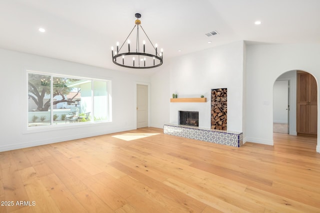 16227 N 63rd Pl, Scottsdale, AZ 85254 - unfurnished living room featuring arched walkways, light wood-style floors, a chandelier, baseboards, and recessed lighting