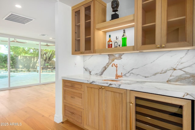 16227 N 63rd Pl, Scottsdale, AZ 85254 - indoor dry bar featuring beverage cooler, backsplash, light wood-style floors, a wall of windows, and recessed lighting