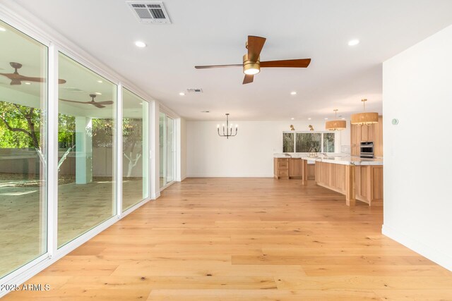 16227 N 63rd Pl, Scottsdale, AZ 85254 - unfurnished living room featuring a ceiling fan, light wood finished floors, recessed lighting, and a chandelier