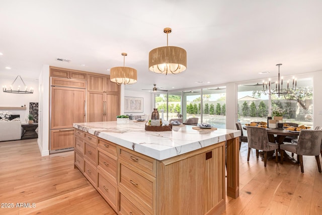 16227 N 63rd Pl, Scottsdale, AZ 85254 - kitchen with a chandelier, paneled built in refrigerator, light wood-style floors, a kitchen island, and recessed lighting