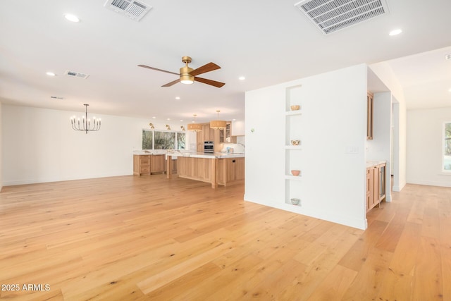 16227 N 63rd Pl, Scottsdale, AZ 85254 - unfurnished living room with light wood-style flooring, recessed lighting, a chandelier, a ceiling fan, and healthy amount of natural light