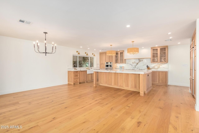 16227 N 63rd Pl, Scottsdale, AZ 85254 - kitchen featuring a chandelier, recessed lighting, light wood finished floors, backsplash, and glass insert cabinets