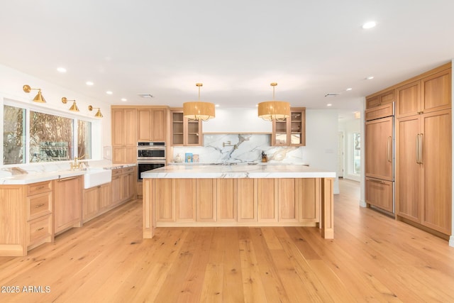 16227 N 63rd Pl, Scottsdale, AZ 85254 - kitchen with paneled fridge, a sink, light wood-style flooring, tasteful backsplash, and healthy amount of natural light