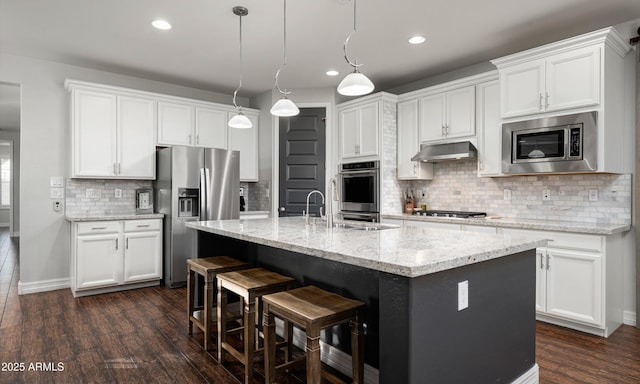 2915 W Night Owl Ln, Phoenix, AZ 85085 - kitchen with appliances with stainless steel finishes, dark wood-type flooring, backsplash, white cabinetry, and recessed lighting
