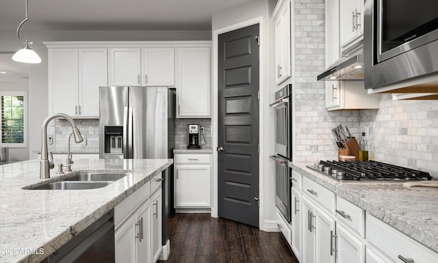 2915 W Night Owl Ln, Phoenix, AZ 85085 - kitchen featuring appliances with stainless steel finishes, a sink, white cabinets, dark wood-style floors, and decorative backsplash